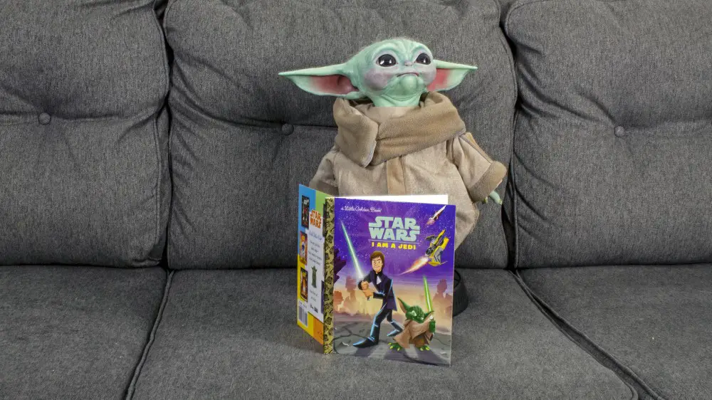Baby Yoda junto a un libro infantil de 'Star Wars'.